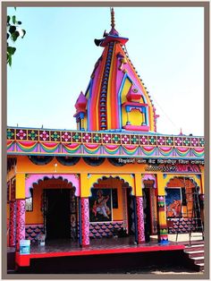 a brightly colored building with an elaborate roof