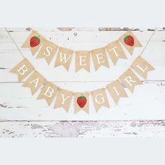 a baby shower banner with strawberries on it