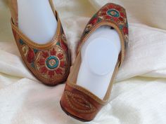 Colorful, embroidered women’s leather shoes and sandals from India: Fashion footwear for the contemporary city dweller, from five centuries back. Mumtaz, the lady for whom the Taj Mahal was built probably lived in shoes and sandals much like these. Originally meant for the Maharajahs and the Maharanis [Kings and Queens and such royalty], these handcrafted fashion footwear for men and women mainly come from the villages of Punjab and Rajasthan. This period fashion piece was introduced to India du Traditional Festival Sandals With Leather Sole, Traditional Leather Sole Festival Sandals, Handwork Flats For Summer Festival, Traditional Hand Tooled Leather Sandals, Summer Festival Flats With Handwork, Traditional Embroidered Closed Toe Sandals, Traditional Hand Tooled Closed Toe Sandals, Traditional Embroidered Round Toe Sandals, Handmade Traditional Slip-on Flats