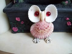 an owl figurine sitting on top of a table next to a black box