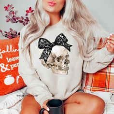 Our Halloween sweatshirt makes the perfect addition to your wardrobe this Halloween.  PLEASE NOTE: THIS SWEATSHIRT IS A UNISEX FIT SO IT DOES RUN A LITTLE BIGGER THAN A NORMAL WOMEN'S SWEATSHIRT. PLEASE CHECK THE SIZING CHART IN THE PHOTOS SECTION FOR MEASUREMENTS.   HOW TO ORDER  1. Select the size of each shirt you would like to order. 2. Add the quantity of shirt(s) you would like and then click "Add to Cart" 3. Submit Order  4. During checkout please provide any additional information in the Halloween Cotton Sweatshirt With Skull Print, Fall Skull Print Long Sleeve T-shirt, Fall Skull Print Crew Neck Top, Long Sleeve Skull Print T-shirt For Fall, Spooky Skull Print Top For Fall, Spooky Skull Print Tops For Fall, Halloween Cotton Sweatshirt With Skull Design, Halloween Skull Print Crew Neck Sweatshirt, Funny Halloween Shirts