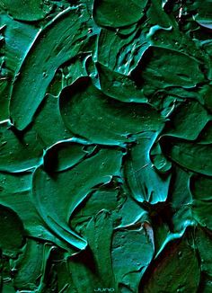 a close up view of green paint on a surface that looks like it has been painted