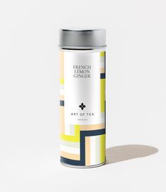 a tin can with an art of tea label on it sitting on a white surface