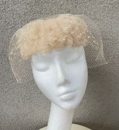 Vintage 60s pillbox formal hat beige netting with pearls size 21". No labels, good condition but netting has two holes ( last photo). Man made fabrics and 2 layers of netting. Measurements  Width 3" Width hat 8" Interior circumference 21" Netting drop from rim 3"  Weight 10 oz Vintage Cream Fascinator Hat, White Pillbox Hat, Pearl Hat, 30s Pillbox Hat, Fur Pillbox Hat, 1960s Pillbox Hat, Formal Hat, Imperial Beach, Large Brim Hat