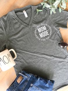 MOM MODE ALL DAY EVERYDAY LOGO TEE (UNISEX) We love this shirt! it is super cute and Simple but doesn't down play being a mom! Shirt is made of 50% cotton and 50% polyester It is super soft and comfortable, great for dressing down around the house or dressing up to go out with friends. AN EVERYDAY tee. Image is made of high quality vinyl and pressed onto shirt with heat press. WASHING INSTRUCTIONS We recommend to wash shirt inside out on cold and dry on delicate PLEASE SEE SIZING CHART LOCATED I Shirts For Moms, Boutique Business, Shirt Inspiration, Funny Mom Shirt, All Day Everyday, Being A Mom, Tshirt Ideas, Mom Life Shirt, Vinyl Shirts