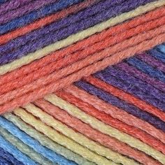 multicolored skeins of yarn are stacked together