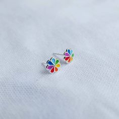 Real 925 Sterling Silver Colorful Rainbow Boho Flower Stud Earrings These lovely earrings can be used in Earlobe, Tragus and Cartilage. Made from colorful Enamel Measures 7mm Comes with pushback backings Sold by Pair Jewelry will come in a gift box * Please read shop policy before placing an order * *JEWELRY CARE* Sterling Silver will tarnish over time, but to help keep your jewelry looking beautiful - Clean with a soft dry cloth after wear and store inside an airtight bag or container. Remember Lgbtq Jewelry, Argentium Silver Jewelry, Rainbow Boho, Paired Jewelry, Rainbow Flower, Flower Stud Earrings, Flower Stud, Argentium Silver, Colorful Rainbow