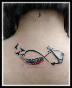 the back of a woman's neck with an anchor and birds on it