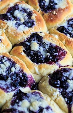 blueberry rolls with powdered sugar on top are ready to be eaten for breakfast