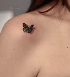 a woman's shoulder with a butterfly tattoo on her left shoulder and the upper half of her breast visible