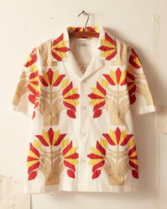 This short sleeve shirt is inspired by an unfinished quilt top from the 1900s. The shirt features a faithful reproduction of an unfinished appliqué quilt top of turkey red and yellow bunches of flowers.  Boxy, cropped fit  Four front buttons  100% cotton  Made in India   Dry clean only View all shirts All wear, mending Bunches Of Flowers, New York Shopping, Victorian Quilts, Lace Long Sleeve Shirt, Floral Long Sleeve Shirt, Applique Shirts, Quirky Fashion, Long Sleeve Plaid Shirt, Men Shirt Style