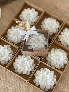 some white flowers are in a box on the table