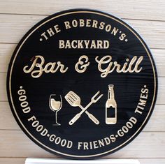 a black and gold sign for a bar and grill with wine glasses, utensils and bottles