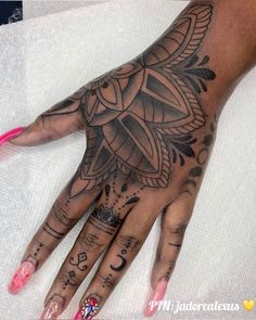 a woman's hand with tattoos on it