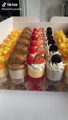 an assortment of desserts are arranged in a box