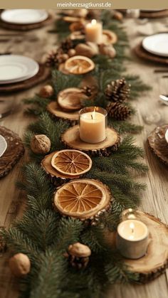 the table is decorated with pine cones, orange slices and candles