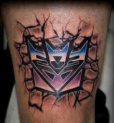 a man's leg with a tattoo on it that has an image of a transformer