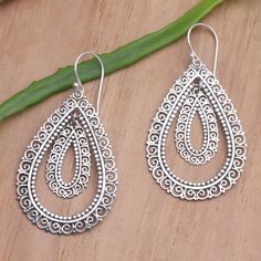 The mesmerizing designs on Made Suyana's dangle earrings will leave you giddy with excitement. The Balinese artisan uses sterling silver to create the earrings, hand crafting intricate, openwork designs that radiate around concentric teardrops. Ornate Sterling Silver Nickel-free Chandelier Earrings, Sterling Silver Dangle Jewelry With Intricate Design, Ornate Sterling Silver Teardrop Earrings For Gift, Ornate Sterling Silver Teardrop Earrings As Gift, Sterling Silver Chandelier Earrings With Intricate Design, Sterling Silver Chandelier Earrings With Intricate Design For Gift, Artisan Sterling Silver Nickel-free Chandelier Earrings, Artisan Sterling Silver Chandelier Earrings Nickel Free, Bohemian Pierced Teardrop Earrings In Sterling Silver