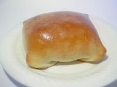 a piece of bread sitting on top of a white plate