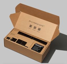 an open cardboard box with some sort of electronic device in it's front and side