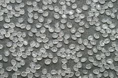 many bubbles are floating in the air on a gray surface with white dots and black background