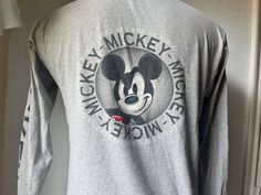 "very good shape   Pit to pit is 19\" Top to bottom is 27 1/2\" Tag size: M Olivia 23 C281" Mickey Mouse Long Sleeve T-shirt For Streetwear, Indian Wolf, Mickey Mouse T Shirt, Team T Shirts, White Tank, White Tank Top, Gray Tshirt, Native American Indians, Black Tshirt