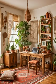 a home office with potted plants in the corner and a rug on the floor