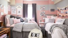 a bedroom decorated in pink, grey and white