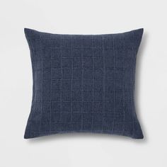 a dark blue pillow on a white background