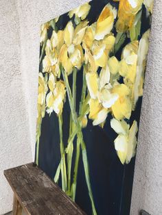 an oil painting of yellow flowers on a black and white background with a wooden bench in the foreground