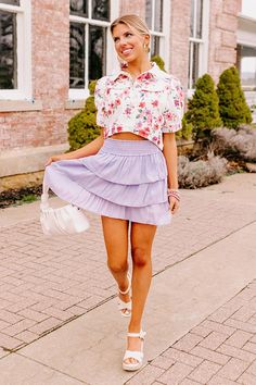 Add a pop of color to your spring wardrobe with our cute lavender hued 'Quince' skirt featuring lightweight material with three flirty tiers, a smocked waistline, and a flirty silhouette that ends in a straight upper-thigh length hemline! Measurements S : Hip 38", Length 17", Waist 22-24". M : Hip 40", Length 17.5", Waist 24-26". L : Hip 42", Length 18", Waist 26-28". Spring Day Out Tiered Skirt, Tiered Skirt For Spring Day Out, Purple Skirt With Elastic Waistband For Summer, Spring Tiered Mini Skirt, Brunch Tiered Mini Skirt, Summer Feminine Tiered Mini Skirt, Tiered Mini Skirt For Brunch In Spring, Tiered Mini Skirt For Spring Brunch, Spring Tiered Ruffled Mini Skirt