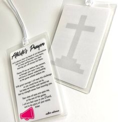 a white tag with a cross on it next to a pink and black marker that says athlete's prayer