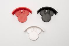 three mickey mouse head shaped cookie cutters sitting on top of a white table next to each other