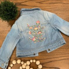 *Nwot* Baby Gap Jean Jacket With The Cutest Embroidered Flowers On The Back! Never Worn; Size 12-18m Spring Cotton Outerwear For Playtime, Cute Outerwear For Spring Playtime, Spring Playtime Outerwear With Pockets, Blue Cotton Outerwear By Gap, Fitted Cotton Outerwear For Playtime, Spring Blue Outerwear From Gap, Fitted Blue Outerwear From Gap, Cute Gap Outerwear For Fall, Cute Gap Cotton Outerwear