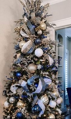 a decorated christmas tree with blue and silver ornaments