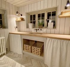 a bathroom with white walls and wooden counter top next to a radiator in the corner