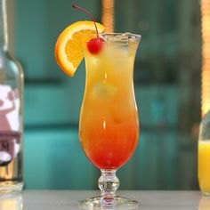 an orange and yellow drink sitting on top of a table