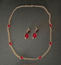 Vintage Napier red glass jewel necklace and screw-back earring set. 14" gold tone necklace with six red glass jewels and working clasp. 2" screw-back earrings. Red Jewelry With Earrings For Evening, Evening Red Metal Jewelry, Evening Gold Ruby Jewelry, Red Costume Jewelry Sets For Formal Occasions, Red Metal Evening Jewelry, Fine Jewelry Red Gold-plated Necklace, Red Multi-stone Jewelry, 14k Gold Red Tarnish-resistant Jewelry, Elegant Red Multi-stone Jewelry