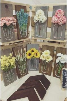 flowers are displayed in mason jars on display