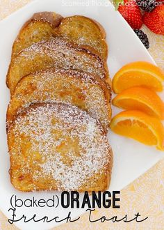 baked orange french toast with powdered sugar on top and fresh fruit in the background