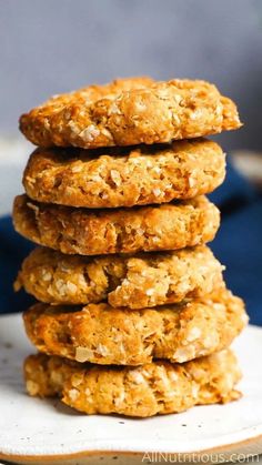 a stack of oatmeal cookies sitting on top of a white plate