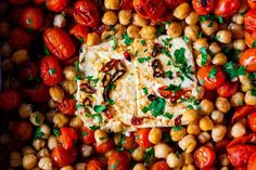 tomatoes, chickpeas and other vegetables are arranged in a pan to make an appetizer