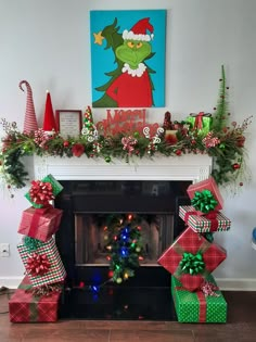 a fireplace decorated for christmas with presents under the mantel and elf hats on top