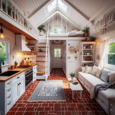 a kitchen and living room in a tiny house with red brick flooring, white walls and ceiling