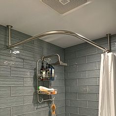 a bathroom with gray tiles and a shower head