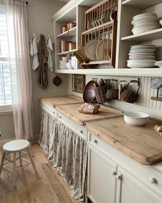 the kitchen is clean and ready to be used for cooking or baking, with dishes on the shelves