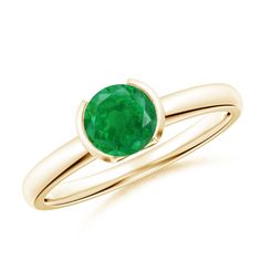 a gold ring with a green stone in the center