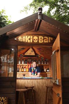 a man sitting at a bar in the woods