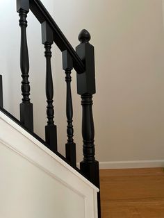 a black banister next to a white door