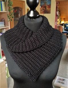 a mannequin wearing a black knitted scarf